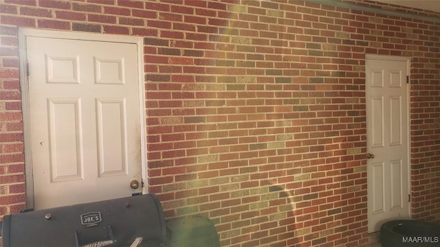 view of exterior entry with brick siding
