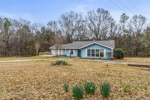 ranch-style house with a garage and a front yard