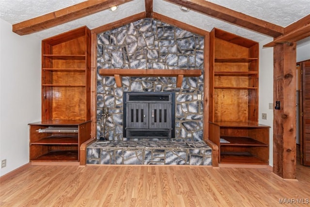 unfurnished living room featuring a textured ceiling, vaulted ceiling with beams, wood finished floors, and heating unit