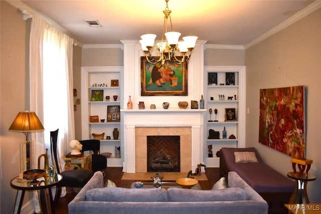 sitting room featuring built in features, crown molding, visible vents, a chandelier, and a tile fireplace