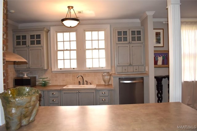 kitchen featuring a sink, appliances with stainless steel finishes, tasteful backsplash, glass insert cabinets, and crown molding