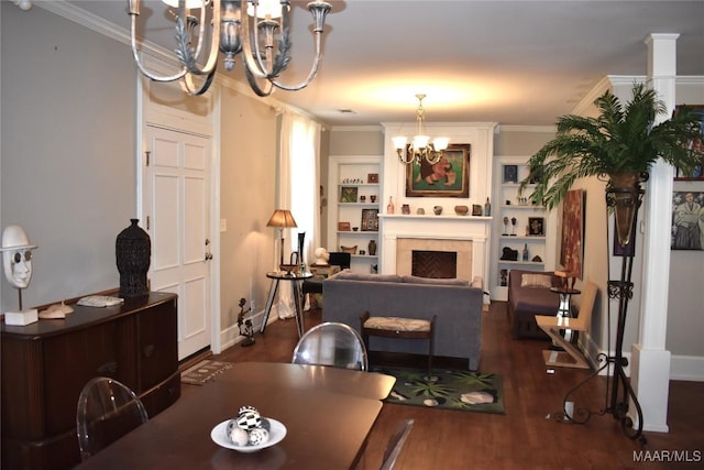 dining room featuring ornamental molding, wood finished floors, and an inviting chandelier