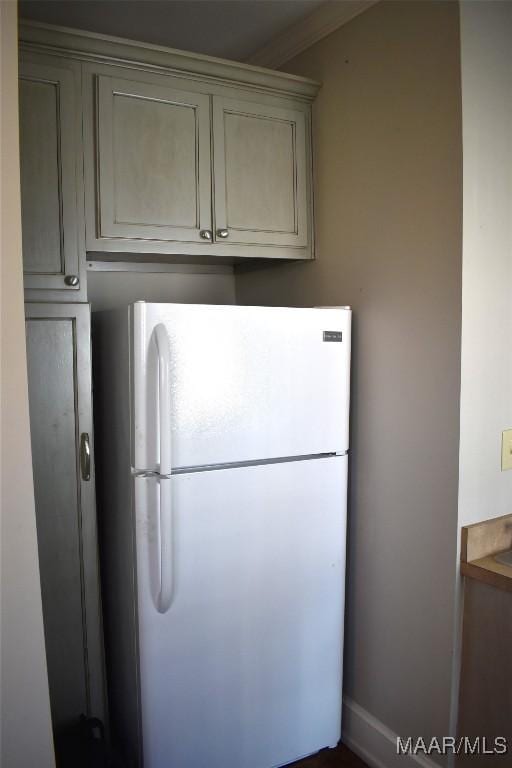 kitchen featuring gray cabinets and freestanding refrigerator