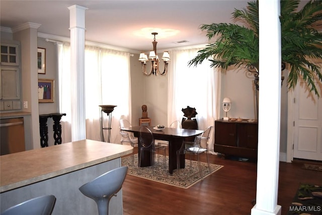 dining space featuring decorative columns, visible vents, ornamental molding, dark wood-style flooring, and an inviting chandelier