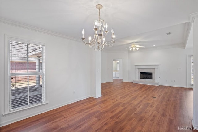 unfurnished living room with a tile fireplace, wood finished floors, visible vents, baseboards, and crown molding