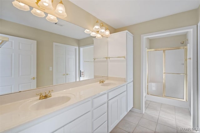 full bathroom with double vanity, tile patterned floors, a sink, and a shower stall