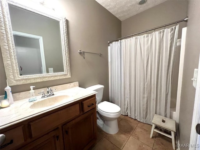 bathroom with toilet, tile patterned flooring, shower / bath combo with shower curtain, a textured ceiling, and vanity