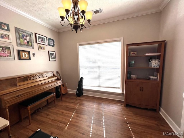 sitting room with visible vents, a textured ceiling, ornamental molding, and wood finished floors