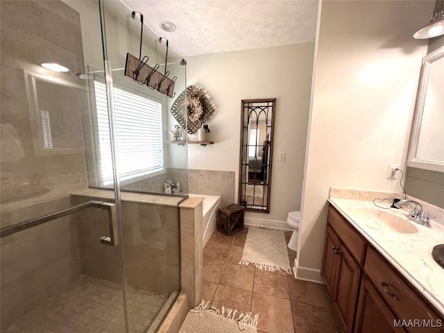 bathroom with a textured ceiling, toilet, vanity, a bath, and a stall shower