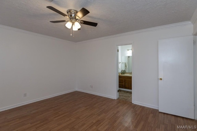 unfurnished bedroom with a textured ceiling, ornamental molding, and wood finished floors