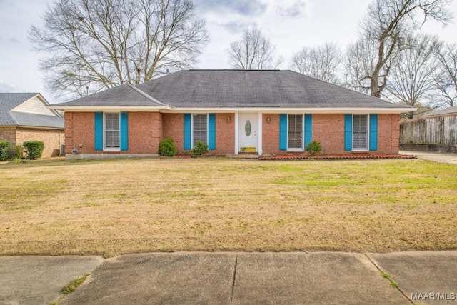 ranch-style house with a front yard and brick siding