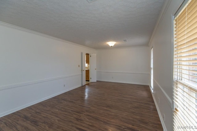 unfurnished room with crown molding, a textured ceiling, baseboards, and dark wood-style flooring