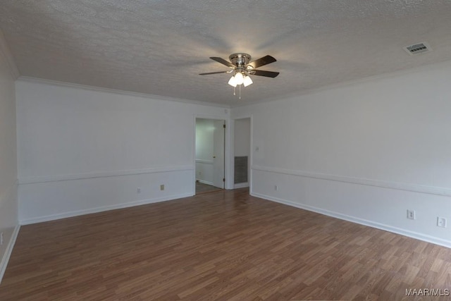 unfurnished room with ceiling fan, a textured ceiling, wood finished floors, and visible vents