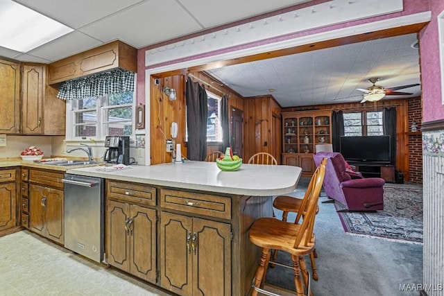 kitchen with a peninsula, a healthy amount of sunlight, and brown cabinets