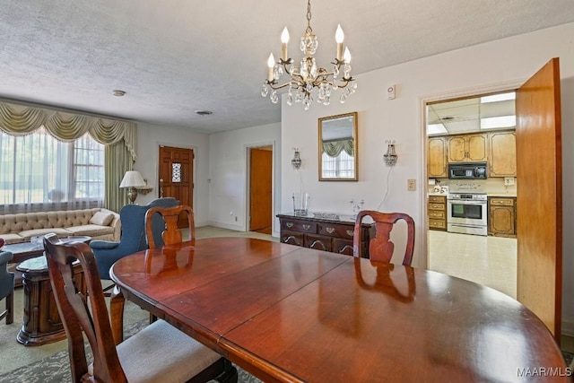 dining room featuring a textured ceiling and a chandelier