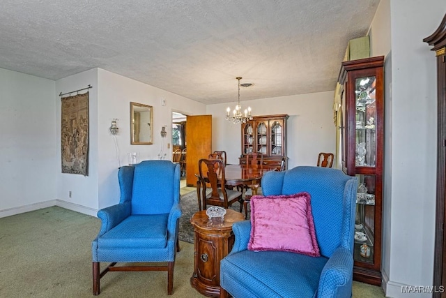 living area featuring carpet floors, an inviting chandelier, baseboards, and a textured ceiling