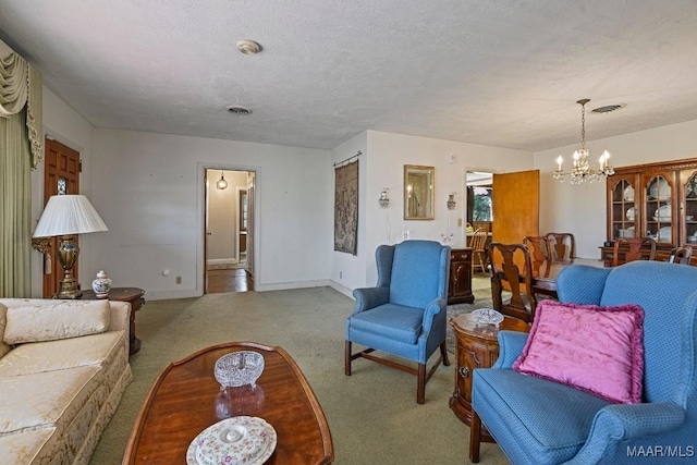 living area with a chandelier, a textured ceiling, visible vents, baseboards, and carpet