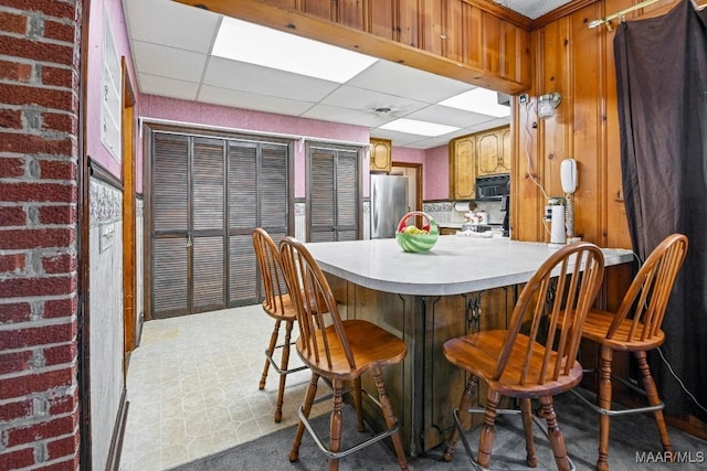 dining space with a paneled ceiling