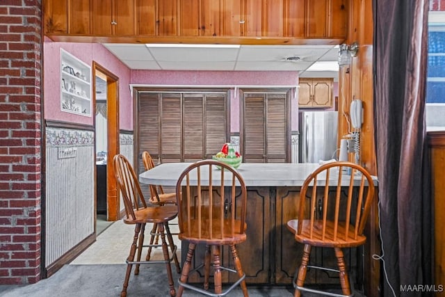 dining room featuring a drop ceiling