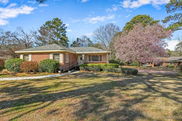 view of front of house with a front lawn and brick siding