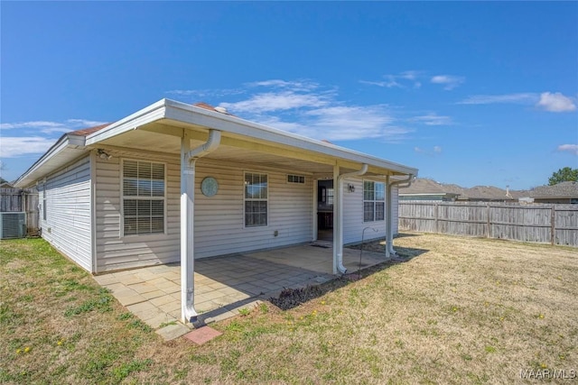 back of property with a yard, central AC, a patio area, and fence