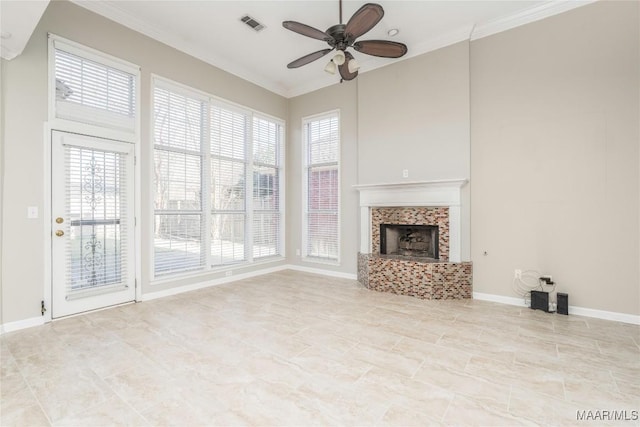 unfurnished living room featuring ornamental molding, a tiled fireplace, a ceiling fan, and baseboards