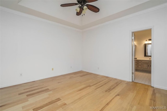 unfurnished room with ceiling fan, light wood finished floors, ornamental molding, and baseboards