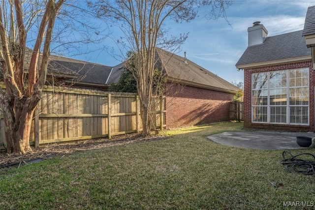 view of yard featuring fence and a patio