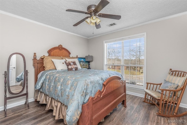 bedroom featuring crown molding, visible vents, a textured ceiling, wood finished floors, and baseboards