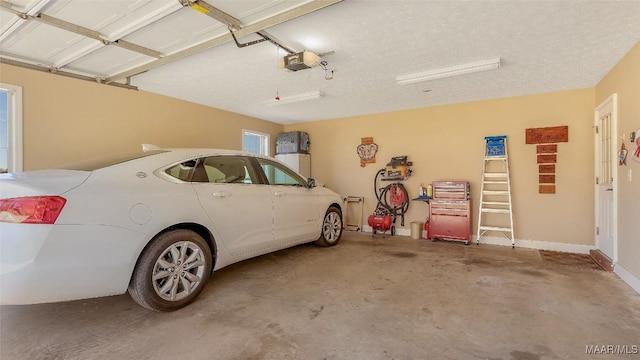 garage with baseboards and a garage door opener