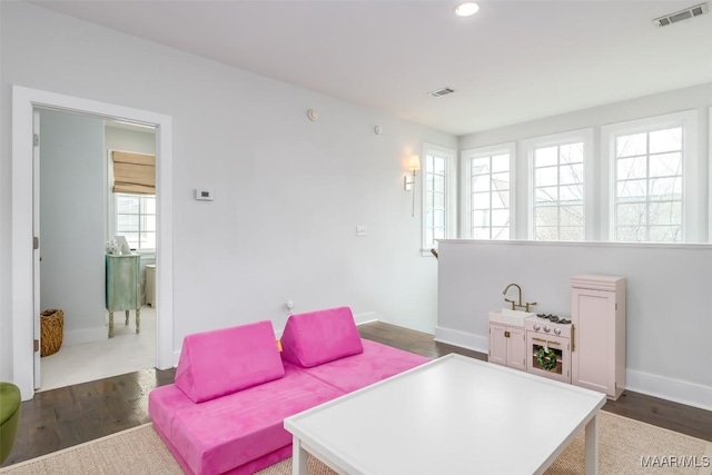7808 Ebury St, Montgomery, AL 36116 - living area with baseboards, visible vents, and dark wood-type flooring