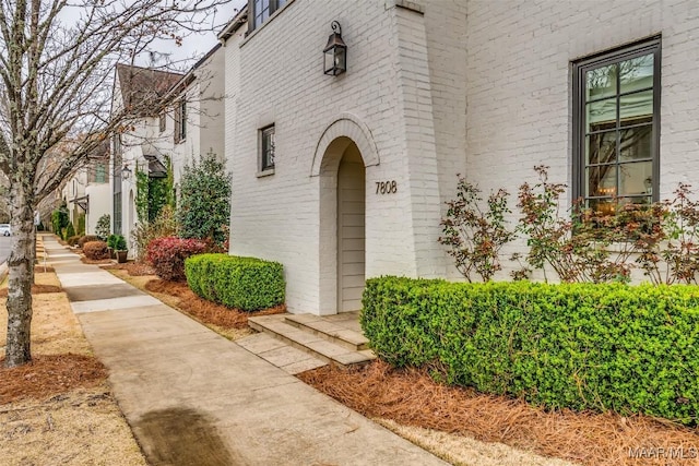 property entrance with brick siding