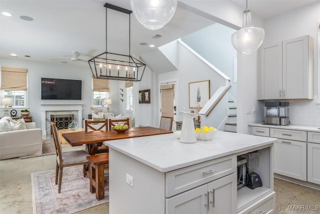 7808 Ebury St, Montgomery, AL 36116 - kitchen featuring a fireplace, visible vents, open floor plan, hanging light fixtures, and backsplash