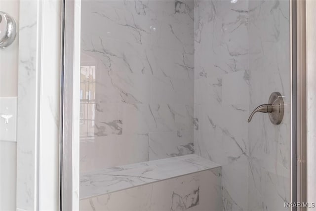 full bathroom featuring a marble finish shower