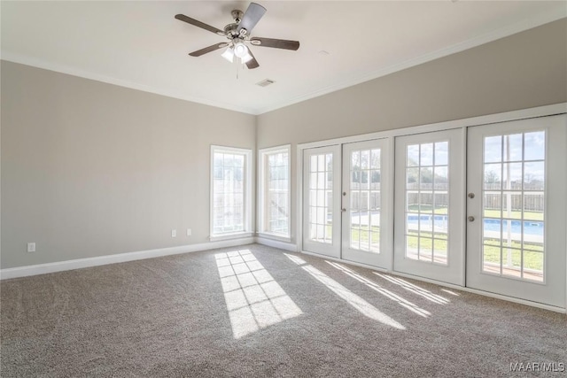 carpeted spare room featuring baseboards, visible vents, ceiling fan, crown molding, and french doors