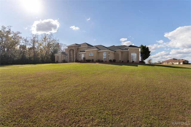 mediterranean / spanish home featuring a front yard