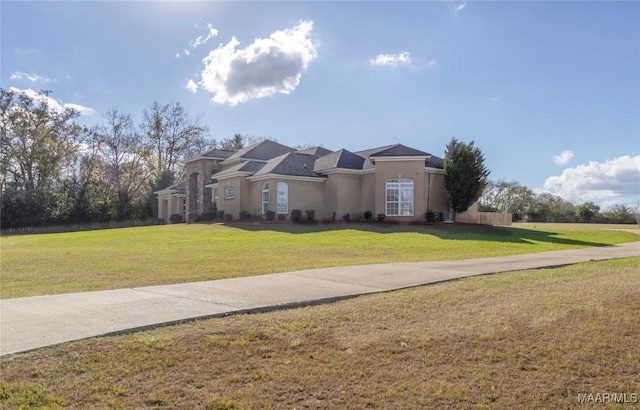 mediterranean / spanish-style house with a front yard and stucco siding