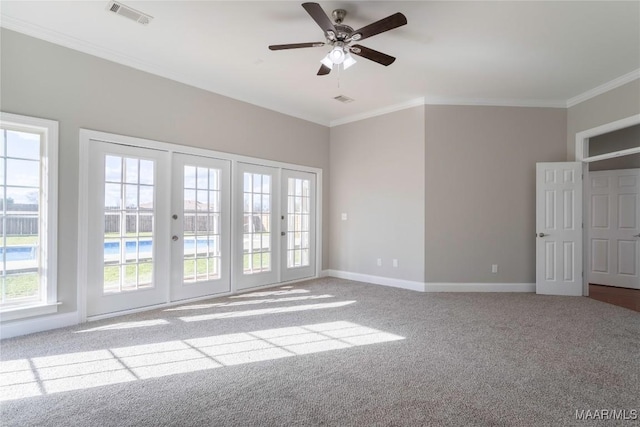 unfurnished room featuring baseboards, visible vents, carpet flooring, and ornamental molding