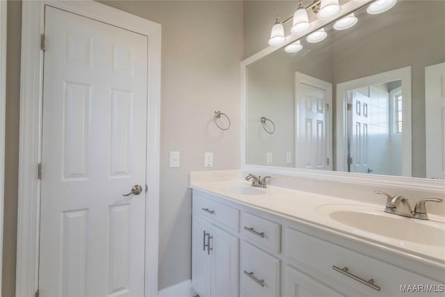 full bath with a sink and double vanity