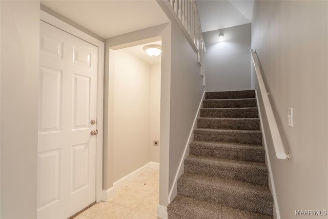 stairs featuring baseboards and tile patterned floors