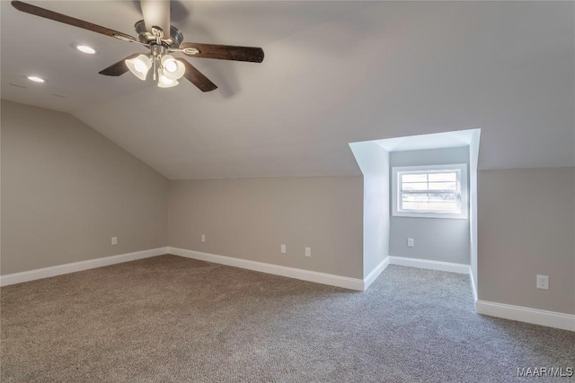 additional living space featuring baseboards, lofted ceiling, ceiling fan, carpet flooring, and recessed lighting