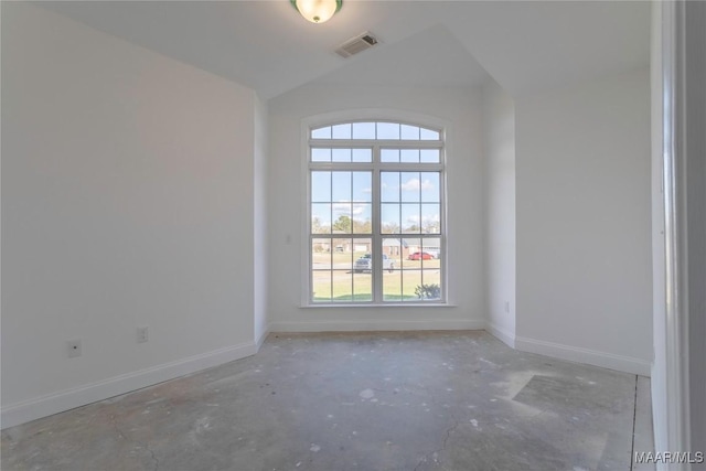 empty room featuring baseboards, concrete floors, and visible vents