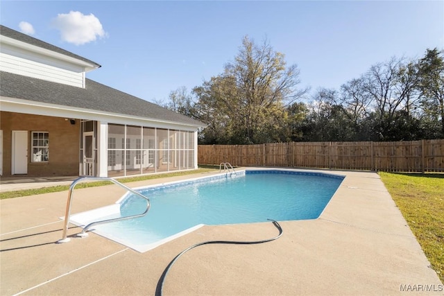 view of pool with a fenced in pool, a sunroom, a patio area, and a fenced backyard