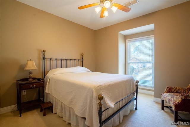 bedroom featuring baseboards, ceiling fan, visible vents, and light colored carpet