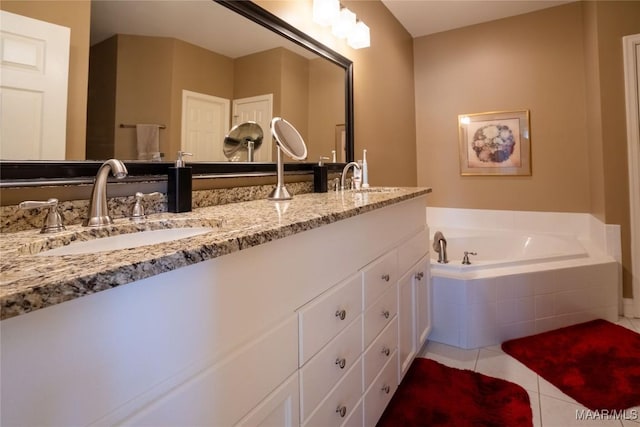 full bath featuring a bath, tile patterned flooring, double vanity, and a sink