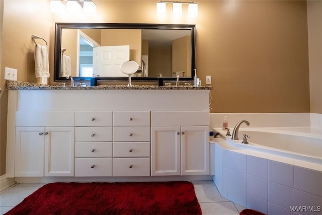 full bathroom with a garden tub, double vanity, a sink, and tile patterned flooring