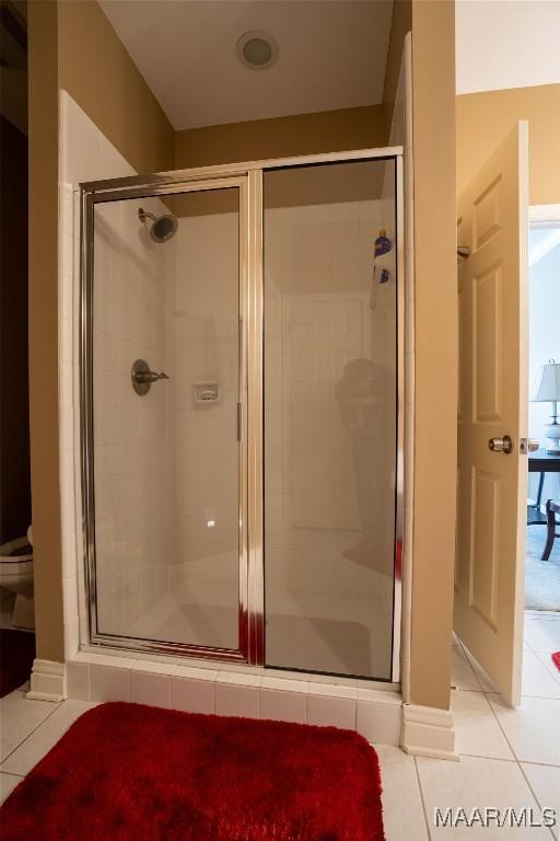 bathroom featuring a stall shower and tile patterned flooring