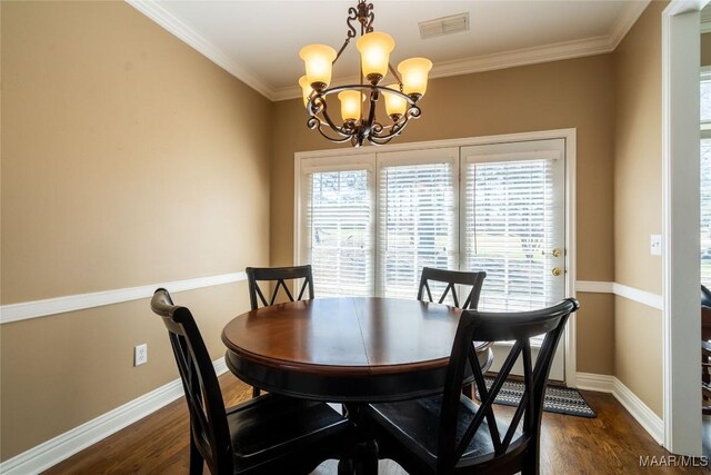 dining area featuring dark wood-style floors, ornamental molding, visible vents, and baseboards