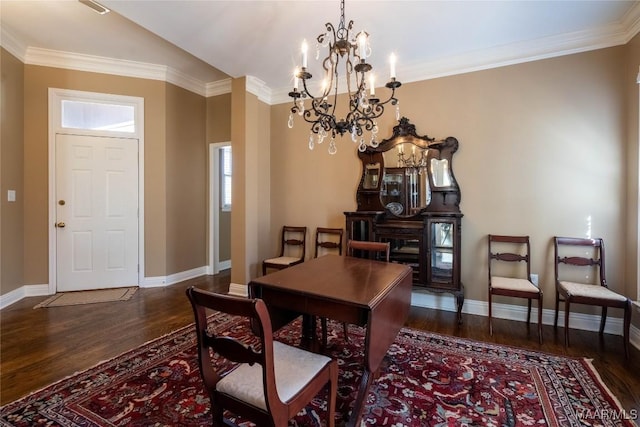 dining area with baseboards, wood finished floors, and an inviting chandelier