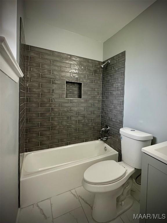 bathroom with washtub / shower combination, marble finish floor, vanity, and toilet